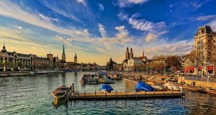 Cityscape with a river and historic buildings.