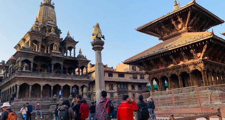 Traditional architecture with tourists exploring the area.