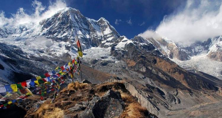 Mountains with snow and prayer flags.