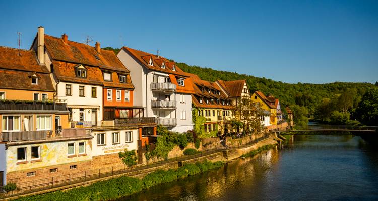 Row of traditional houses alongside a river.