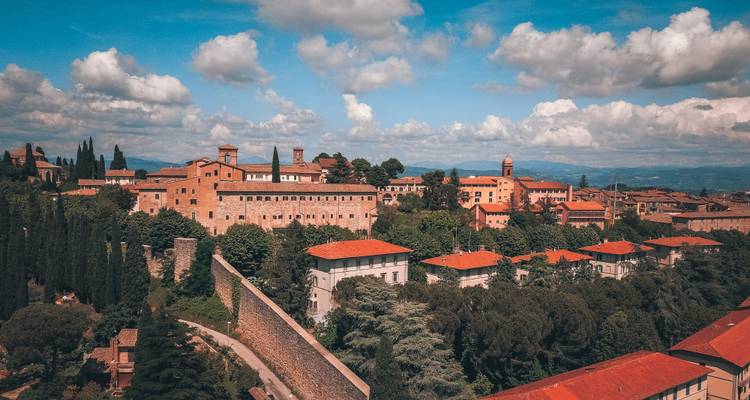 Luchtfoto van een Italiaanse stad met rode dakpannen.