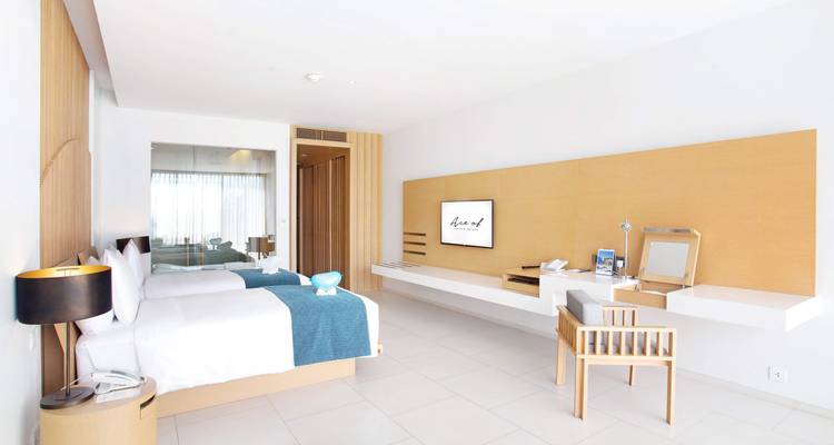 Spacious hotel room with modern minimalist decor.