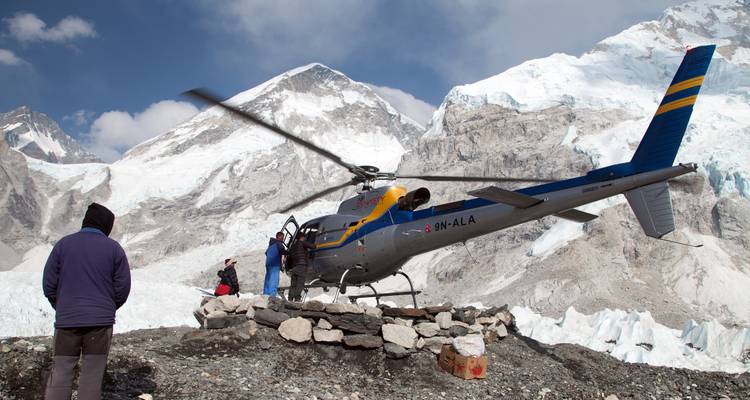 Helicopter on a snowy mountain landscape.
