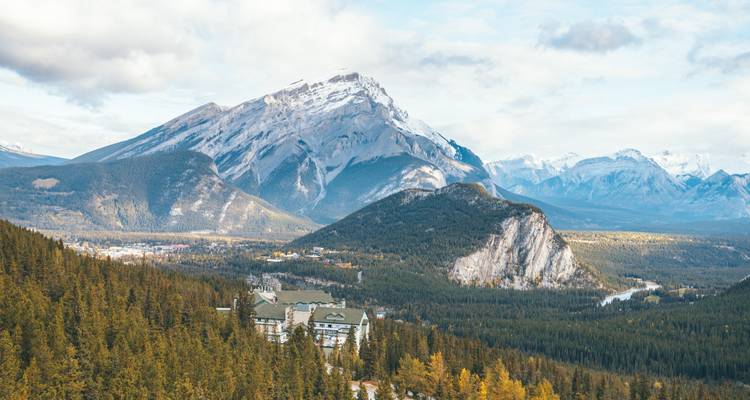 Mountainous landscape with forested area and clear sky.