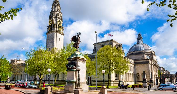 City Hall and other buildings in Cardiff with a statue in the foreground.