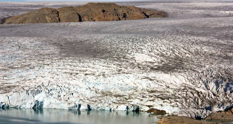 Large ice field with mountains in the background.
