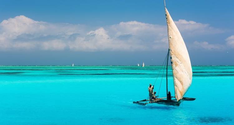 Sailboat on turquoise waters under a blue sky