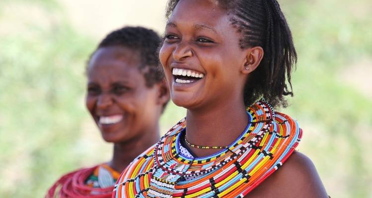 Smiling women wearing traditional beaded necklaces