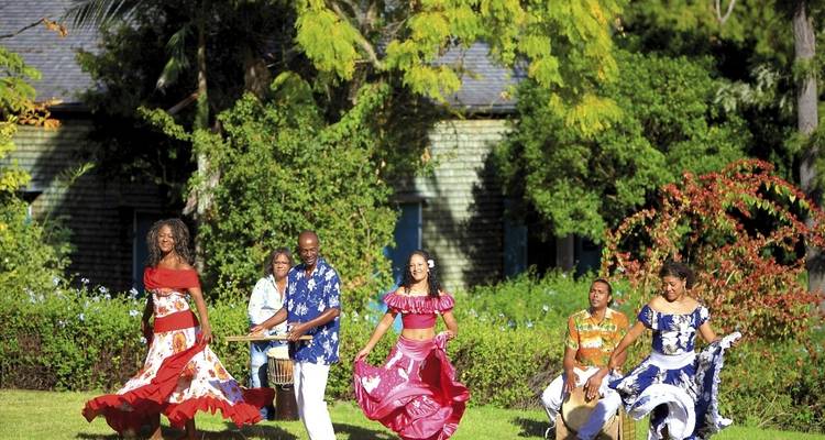 People performing traditional dance outdoors.