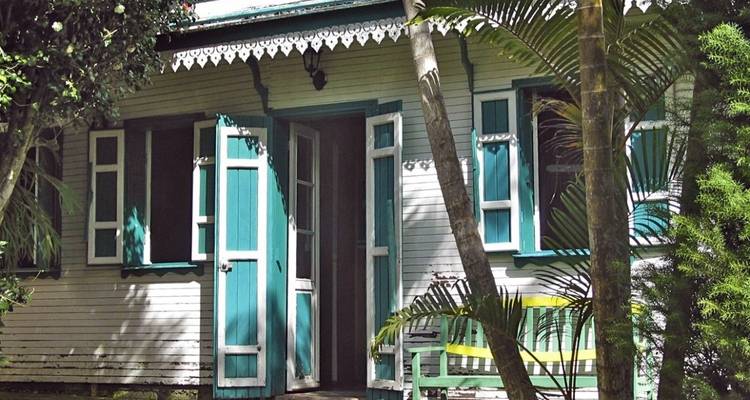 Traditional house surrounded by lush greenery.