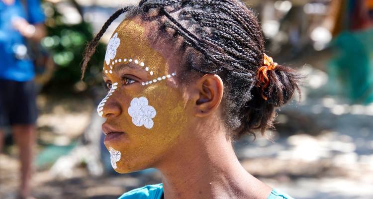 Close-up portrait of a person with traditional face paint.
