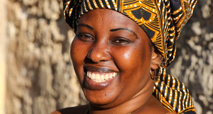 Close-up of a smiling woman wearing traditional attire.