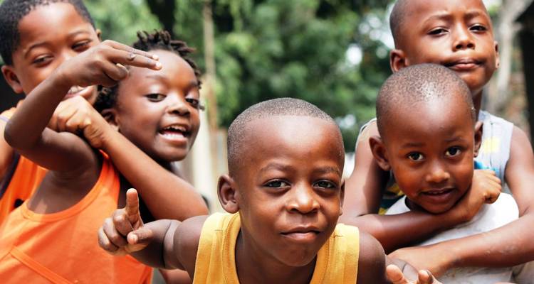 Group of smiling children playing outdoors.