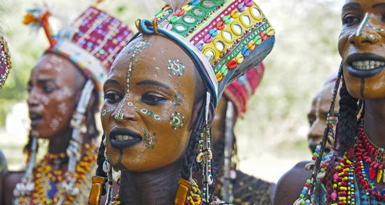 A group with vibrant face paint and traditional attire.