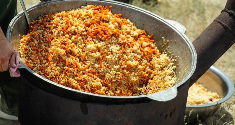 Large pot of cooked rice and vegetables, likely a traditional dish.