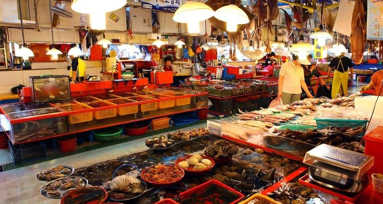 Überfüllter Meeresfrüchtemarkt mit verschiedenen Fischen und Schalentieren.