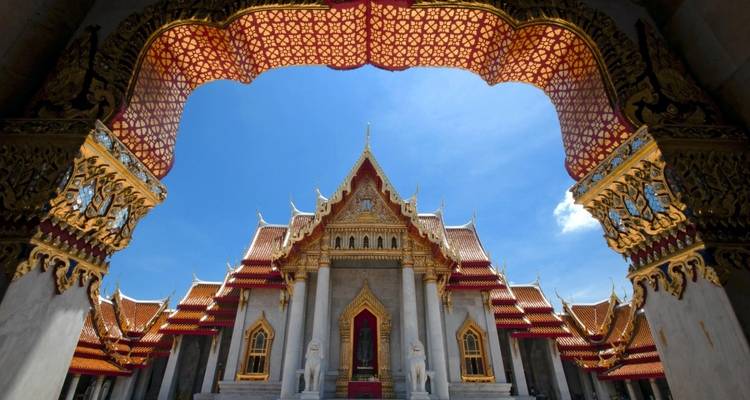 Ornate temple architecture viewed through an archway.