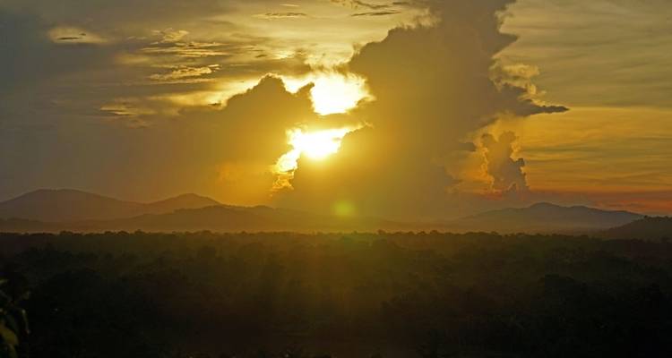 Sunset casting golden hues over a mountainous landscape.