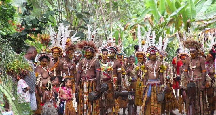 Group of people in traditional attire during a cultural parade.