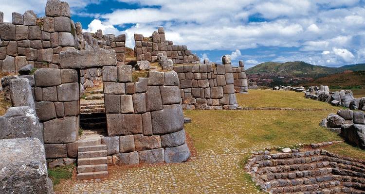 Inca ruins with large stone walls and terraces.