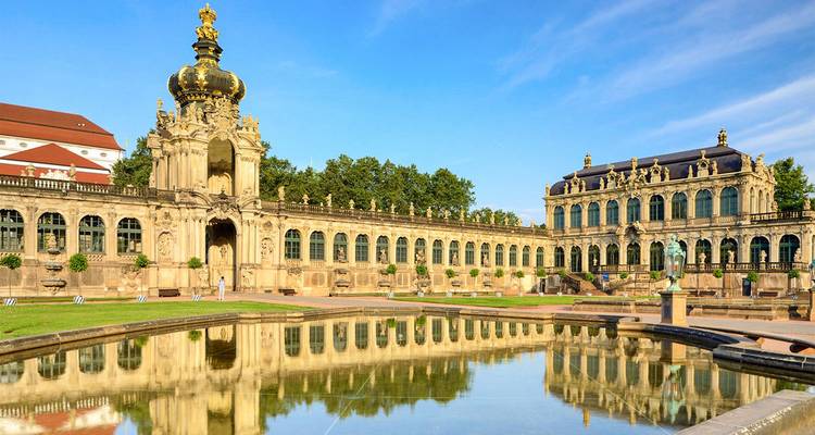 Baroque Zwinger Palace in Dresden reflected in a still pool on a sunny morning.