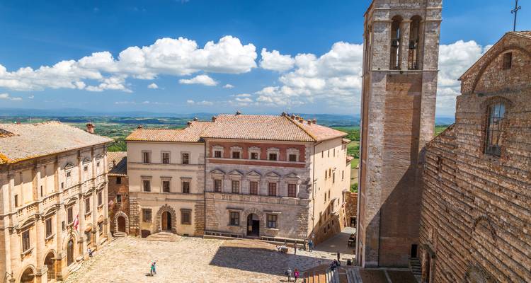 Town square with historic buildings and clear skies.