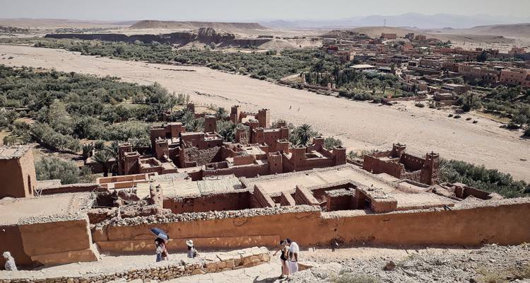 Ruins of an ancient city with tourists exploring.