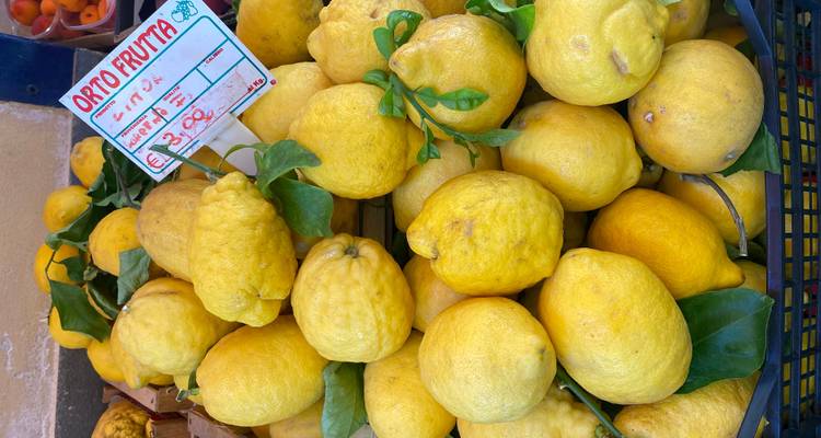 Group of lemons at a market stand.