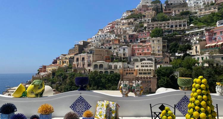 Hillside village with colorful houses and lemons in the foreground.