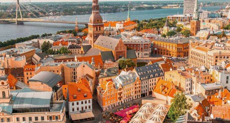 Bird’s-eye view of Riga’s colourful medieval old town by the river on a bright day.