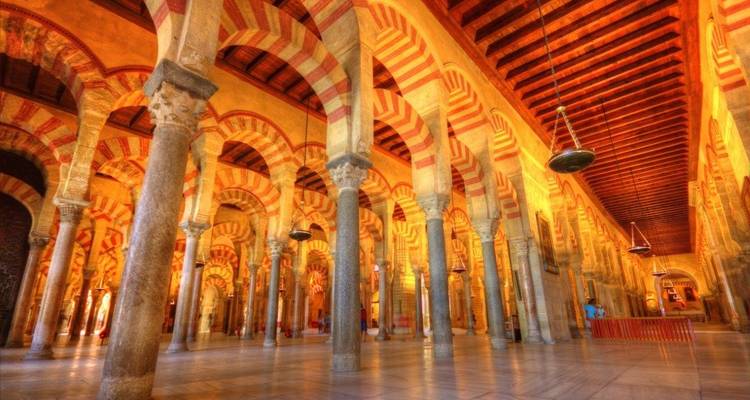 Interior with elegant arches and columns bathed in warm light.