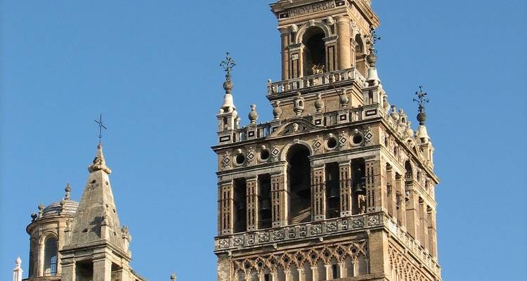 Close-up of the Giralda tower against a clear blue sky.