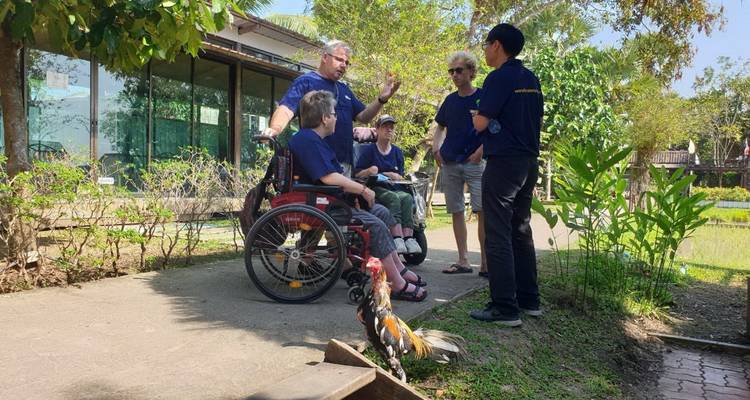 Group of people having a discussion in a garden.
