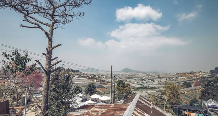 Rooftops and hills under a cloudy sky