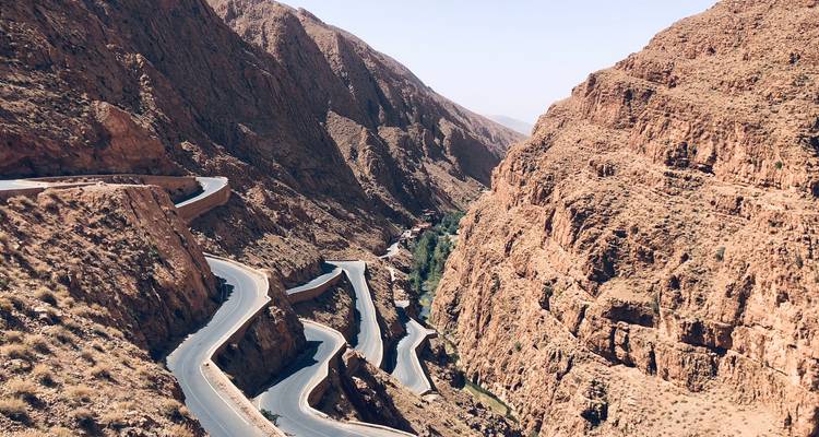Kronkelende weg door een rode rotskloof.