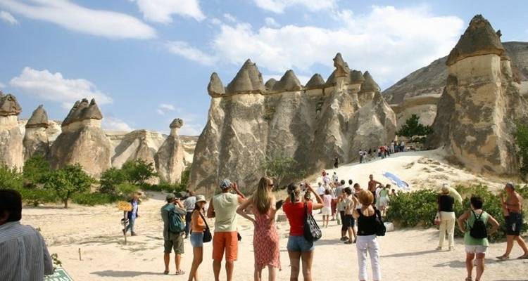 Tourists exploring the fairy chimneys in Cappadocia.