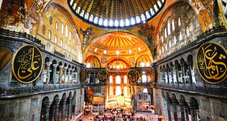 Interior of the Hagia Sophia with visitors inside.