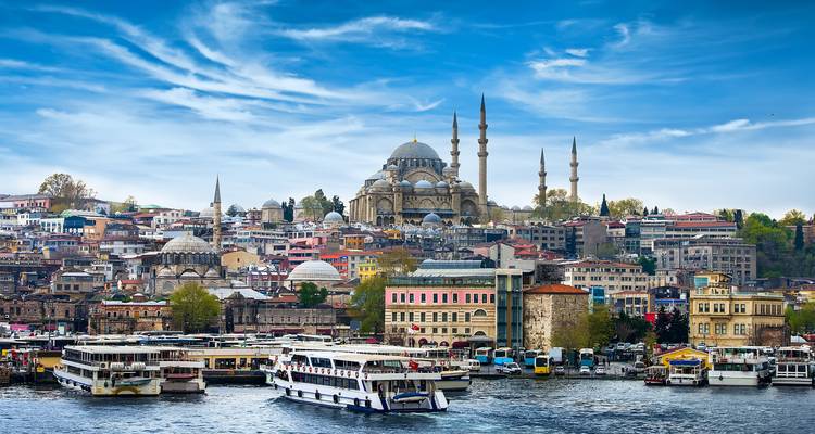 Istanbul cityscape view with boats and the Suleymaniye Mosque.