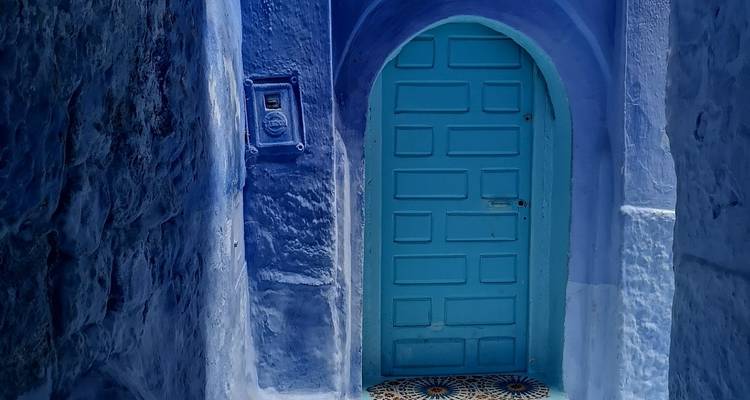 Smalle blauwe steeg met een deur.