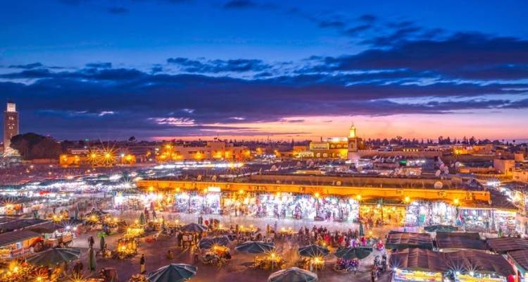 Market at dusk with a vibrant sky.