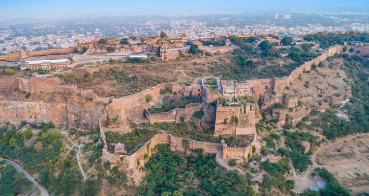 Aerial view of a large fort complex with city in the background.