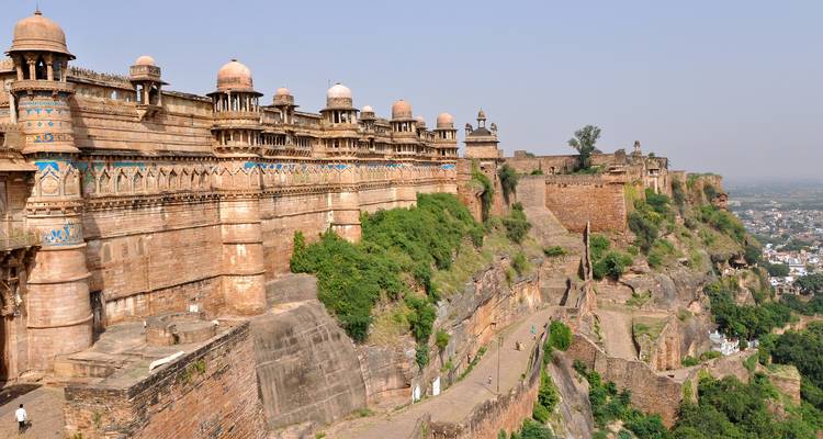 Fort walls and structures overlooking a city.
