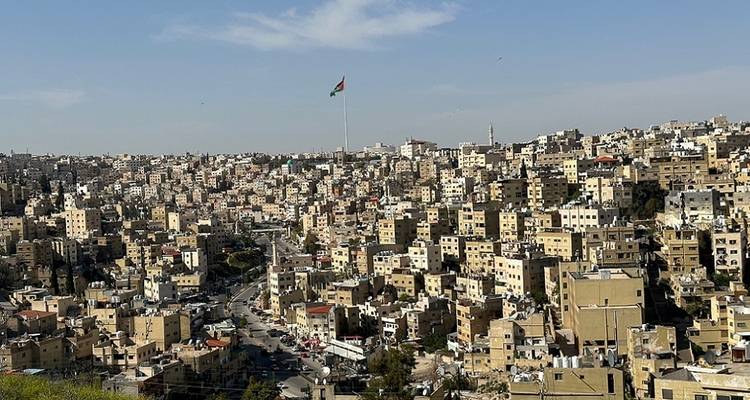 Overview of a city with prominent flag.