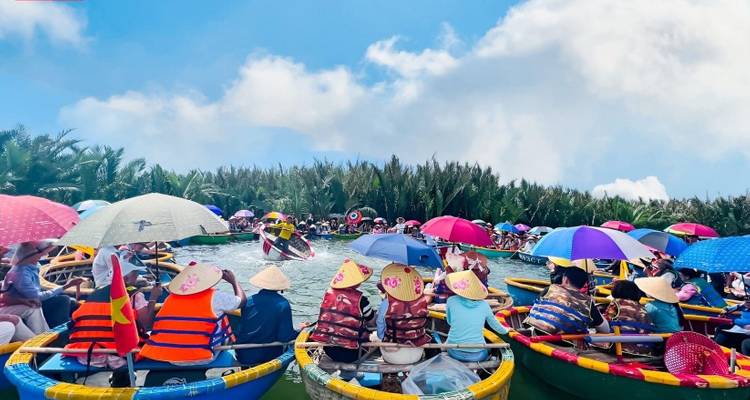 People on boats with colorful umbrellas on a river under a bright sunny sky.