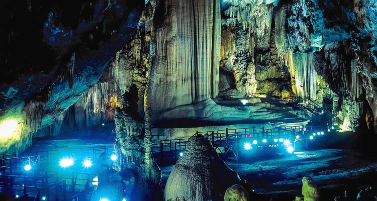 Inside a cave with bright lighting and rock formations.