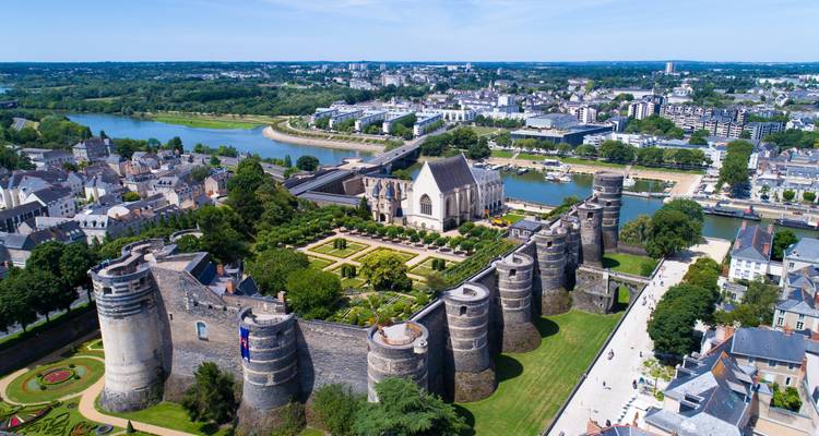 Castle with garden and city view from above.
