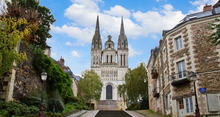 Beautiful cathedral at the end of a cobble-stone street.