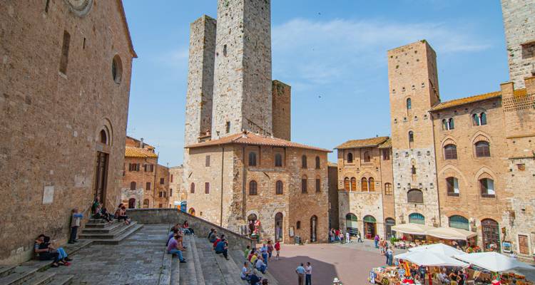 Historic square in San Gimignano with medieval towers.