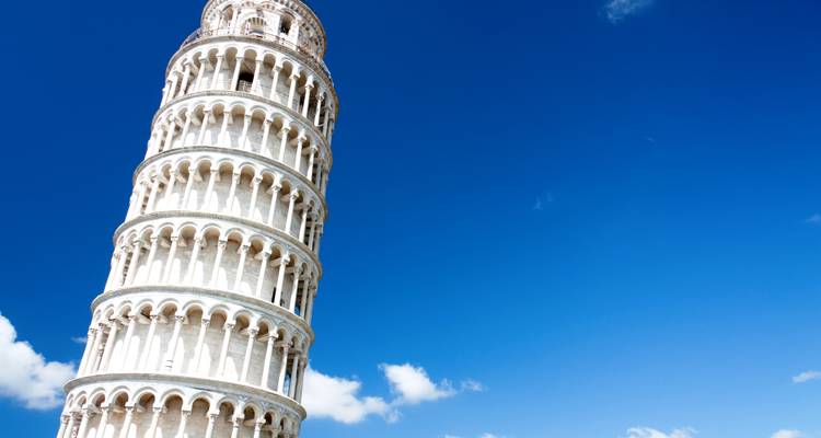 Leaning Tower of Pisa set against a deep blue sky with minimal clouds.