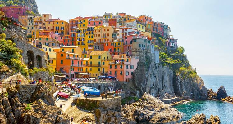 Iconic cliffside village of Manarola with vibrant houses overlooking the Ligurian Sea.